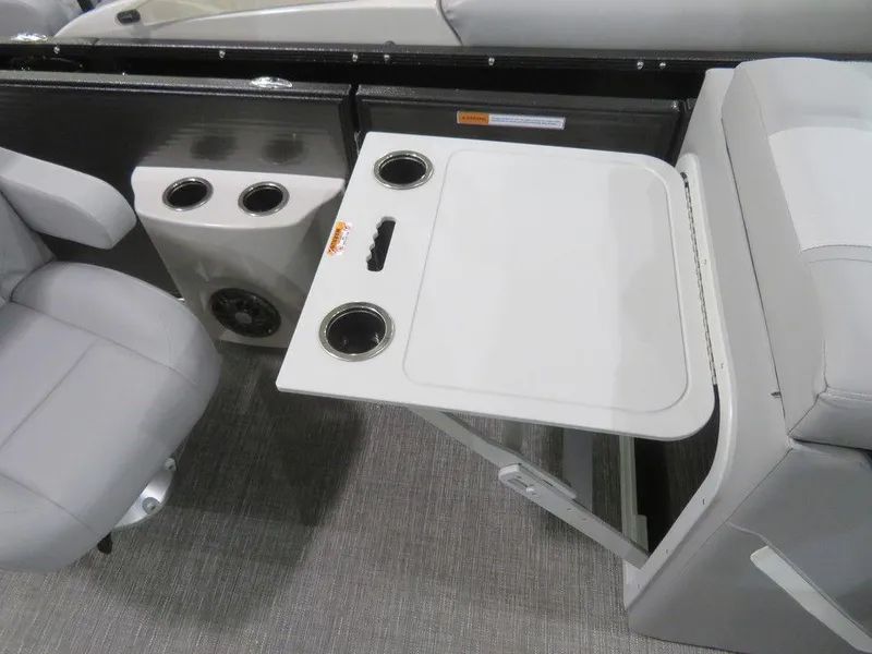 Slide: The Image of 2024 Crest Classic DLX 220 SLSC boat interior with foldable table and cup holders. - 4