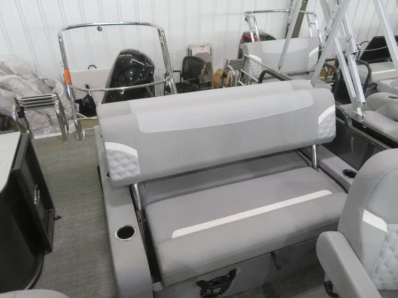 Slide: The Image of 2024 Crest Classic DLX 220 SLSC boat interior with gray seating and cup holders. - 9