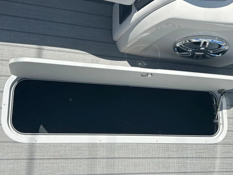 Slide: The Image of Open storage compartment on 2023 Avalon 2785 ENT FS boat. - 13