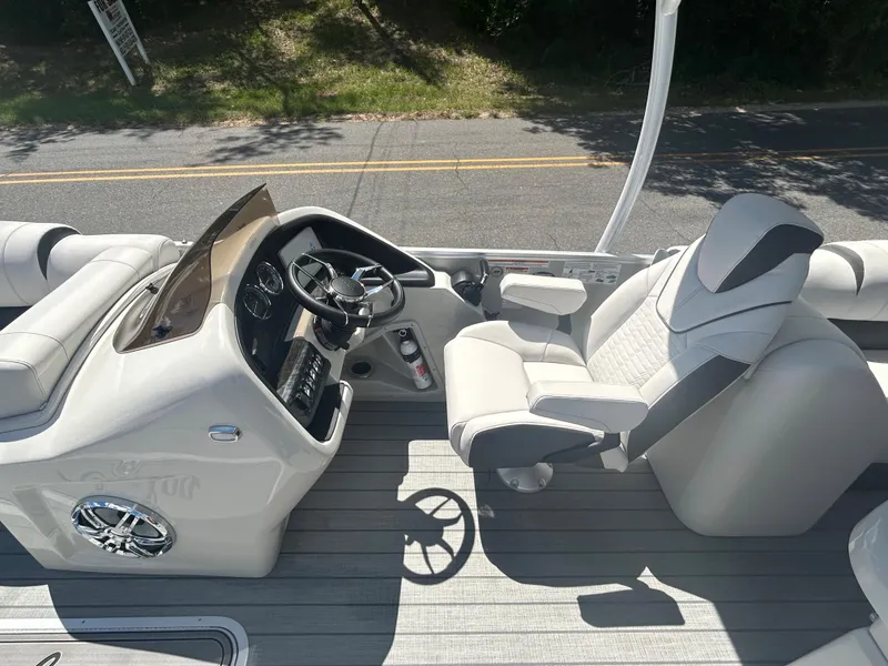 Slide: The Image of 2023 Avalon 2785 ENT FS boat interior with captain's chair and steering console. - 16