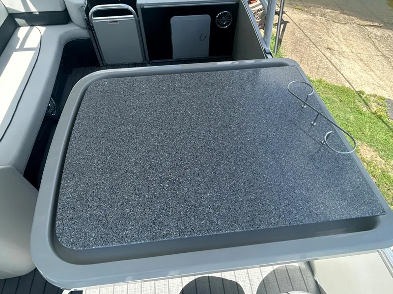 Slide: The Image of 2023 Avalon 2785 ENT FS boat interior with a sleek table and seating area. - 19