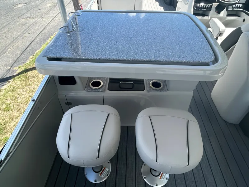 Slide: The Image of 2023 Avalon 2785 ENT FS boat interior with bar table and two stools. - 20