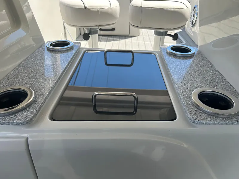 Slide: The Image of 2023 Avalon 2785 ENT FS boat interior with cup holders and seating. - 21