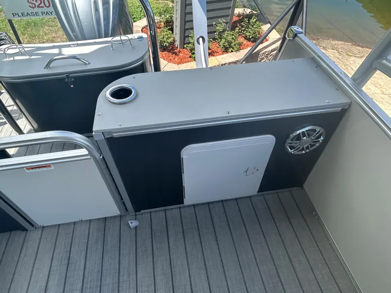 Slide: The Image of 2023 Avalon 2785 ENT FS boat interior with storage compartment and speaker. - 24