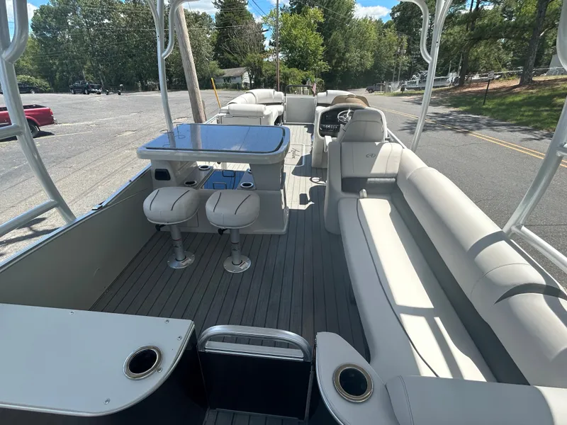 Slide: The Image of 2023 Avalon 2785 ENT FS pontoon boat interior with seating and table. - 25