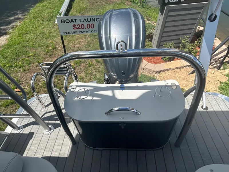 Slide: The Image of 2023 Avalon 2785 ENT FS boat with motor and $20 boat launch sign. - 26