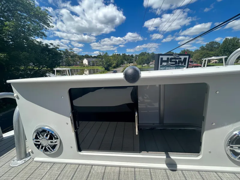 Slide: The Image of 2023 Avalon 2785 ENT FS boat with open storage compartment and speakers. - 31