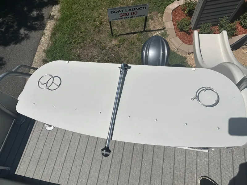 Slide: The Image of 2023 Avalon 2785 ENT FS boat deck with a $20 boat launch sign. - 32