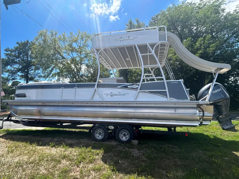 Slide: The Image of 2023 Avalon 2785 ENT FS pontoon boat with slide on trailer. - 4