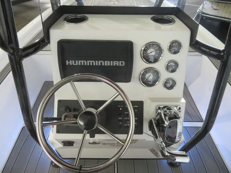 Slide: The Image of 2024 Vexus AVX2180CC boat console with Humminbird electronics and steering wheel. - 13