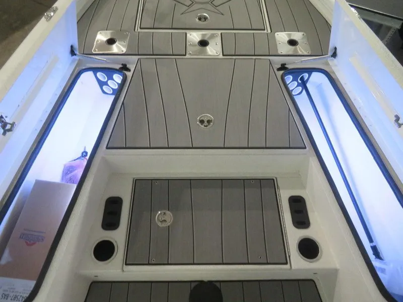 Slide: The Image of 2024 Vexus AVX2180CC boat interior with storage compartments and rod holders. - 18