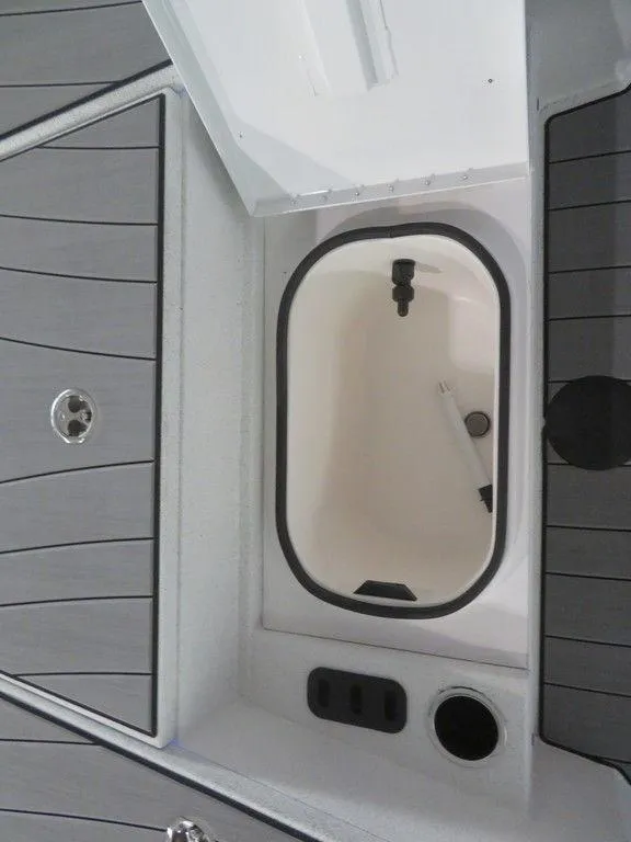 Slide: The Image of 2024 Vexus AVX2180CC boat storage compartment with open lid. - 19