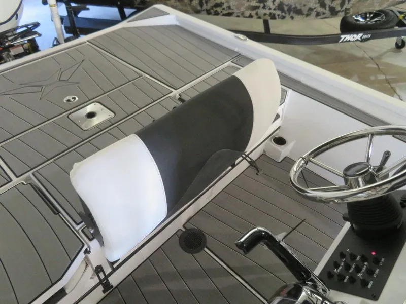 Slide: The Image of 2024 Vexus AVX2180CC boat interior with steering wheel and cushioned seat. - 24