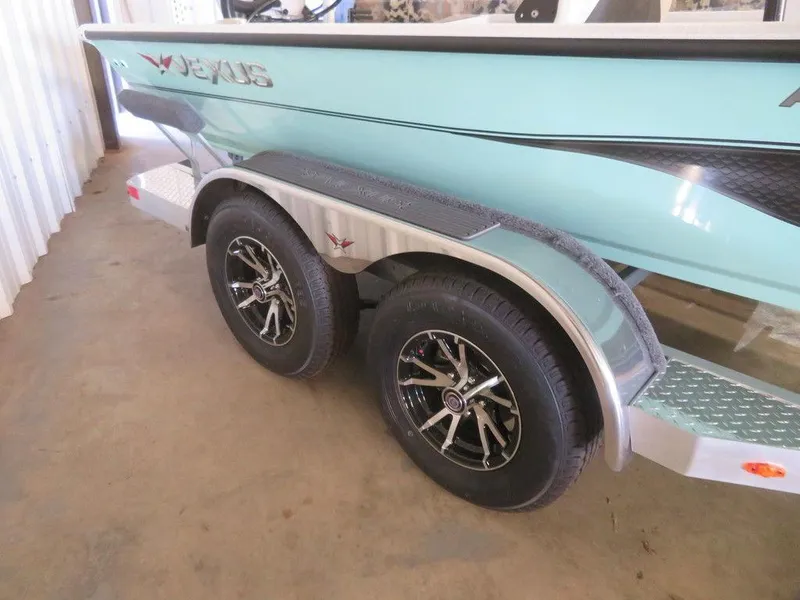 Slide: The Image of 2024 Vexus AVX2180CC boat on a dual-axle trailer in a garage. - 5