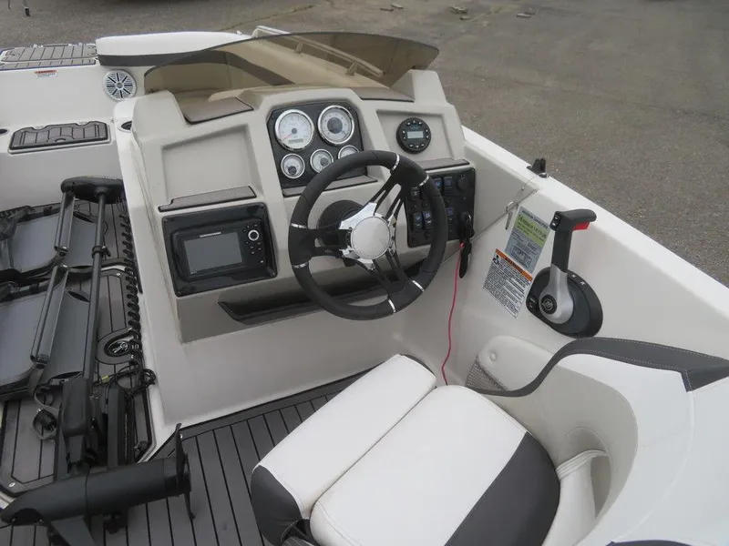 Slide: The Image of 2022 Starcraft SVX211 OB boat cockpit with steering wheel and control panel. - 6