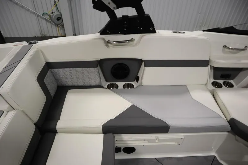 Slide: The Image of 2024 Heyday H20 boat interior with white and gray seating, cup holders, and speaker. - 36
