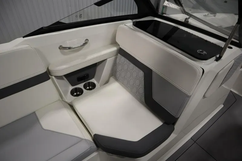 Slide: The Image of 2024 Heyday H20 boat interior with white and gray seating, cup holders, and sleek design. - 39