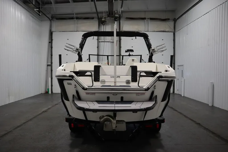 Slide: The Image of 2024 Heyday H20 boat in a garage, rear view showcasing sleek design and features. - 5