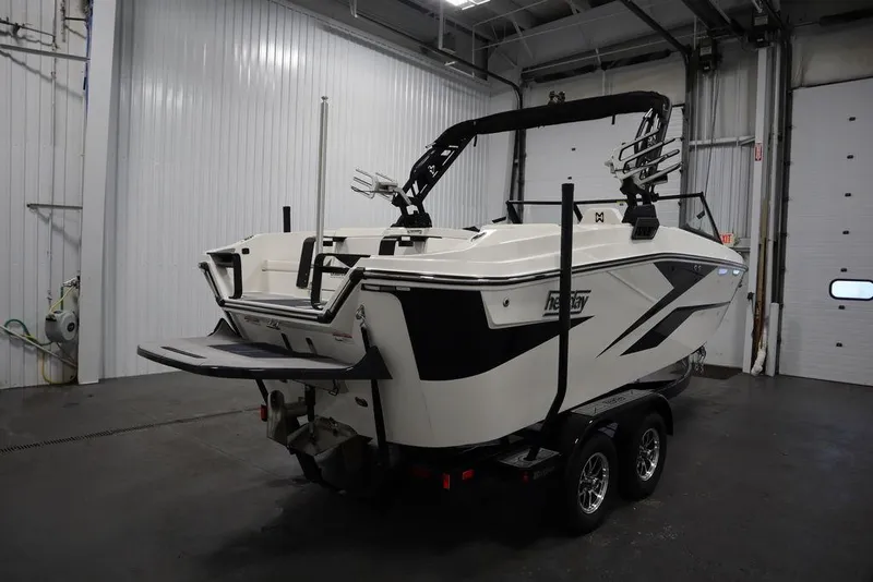 Slide: The Image of 2024 Heyday H20 boat in a garage, rear view, on a trailer. - 7