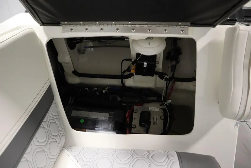 Slide: The Image of Open storage compartment in 2024 Heyday H20 boat, showing internal wiring and components. - 16