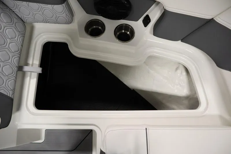 Slide: The Image of 2024 Heyday H20 boat interior storage compartment with cup holders and cushioned seating. - 17