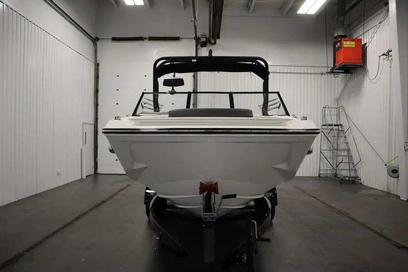 Slide: The Image of 2024 Heyday H20 boat in a garage, front view, white interior walls. - 2
