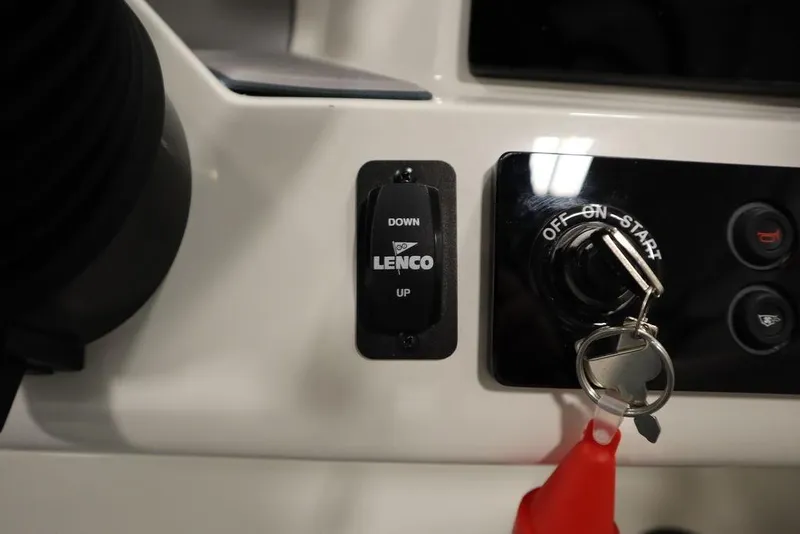 Slide: The Image of 2024 Heyday H20 boat dashboard with Lenco trim tab switch and ignition key. - 29