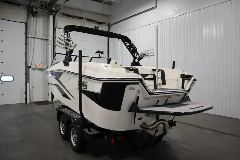 Slide: The Image of 2024 Heyday H20 boat in a garage, rear view with trailer. - 3