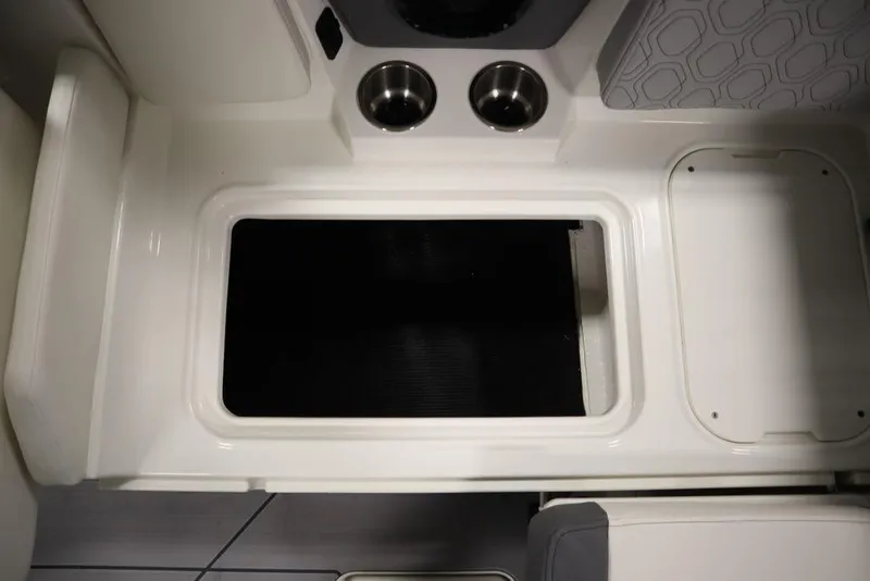 Slide: The Image of 2024 Heyday H20 boat interior with storage compartment and cup holders. - 41