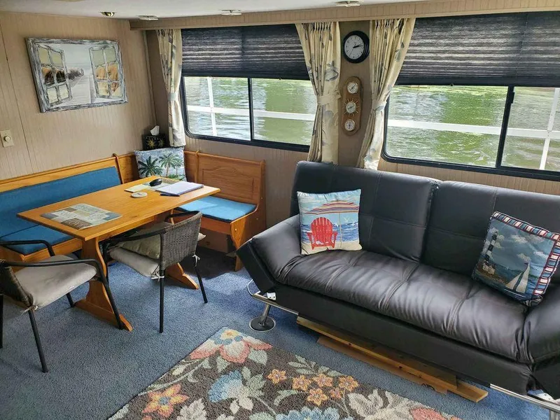 Slide: The Image of Interior of a 1999 Gibson Sport boat with cozy seating and nautical decor. - 3