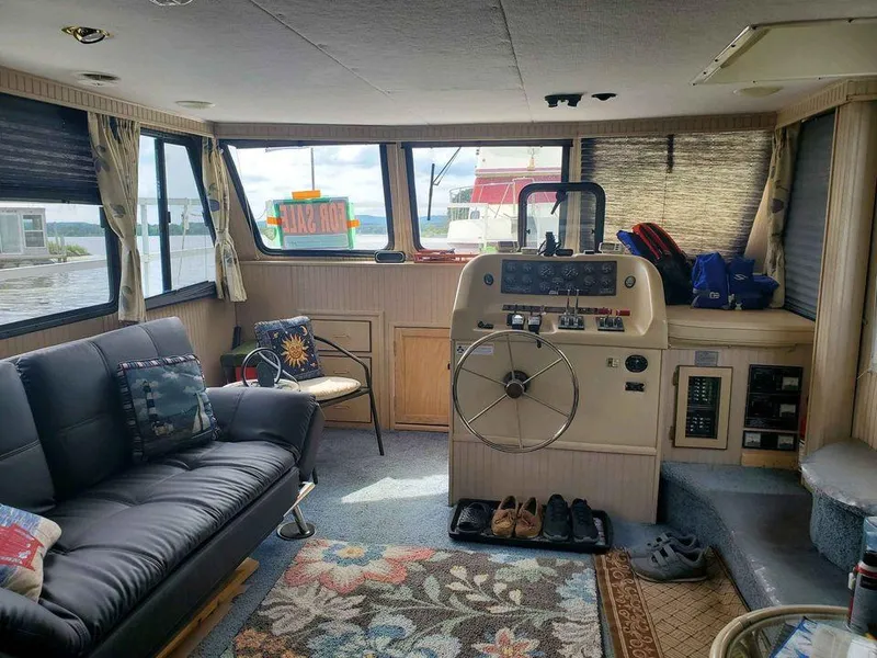 Slide: The Image of Interior of a 1999 Gibson Sport boat with cozy seating and helm. - 5