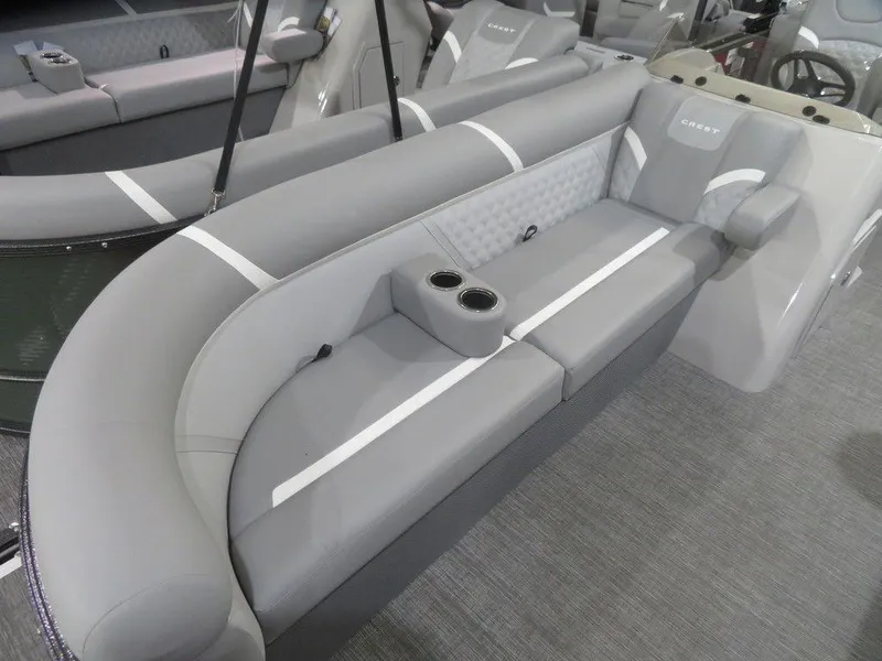 Slide: The Image of 2024 Crest Classic DLX 240 SLC boat interior with gray seating and cup holders. - 3