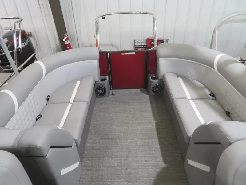 Slide: The Image of 2024 Crest Classic DLX 240 SLC pontoon boat interior with gray seating and red accents. - 9