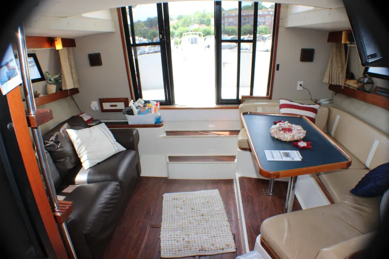 Slide: The Image of Interior of 1986 Carver 3297 Mariner yacht with seating and dining area. - 12