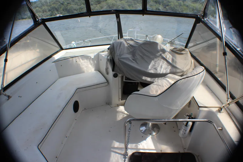 Slide: The Image of Interior view of 1986 Carver 3297 Mariner boat cockpit with covered helm. - 14
