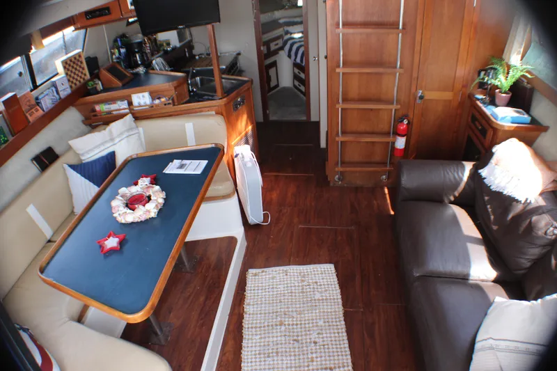 Slide: The Image of Interior of 1986 Carver 3297 Mariner yacht with cozy seating and dining area. - 5
