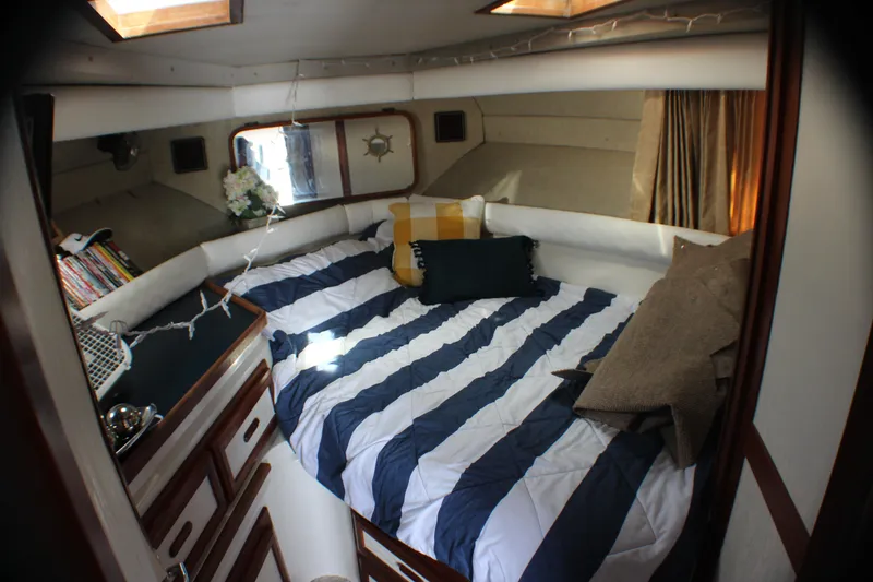 Slide: The Image of Cozy bedroom in 1986 Carver 3297 Mariner yacht with striped bedding and decorative pillows. - 6