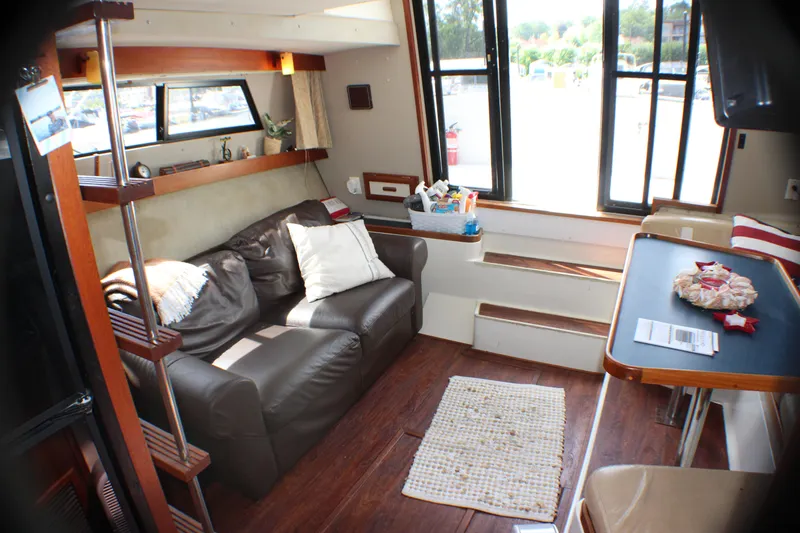 Slide: The Image of Interior of 1986 Carver 3297 Mariner with leather sofa and dining area. - 7