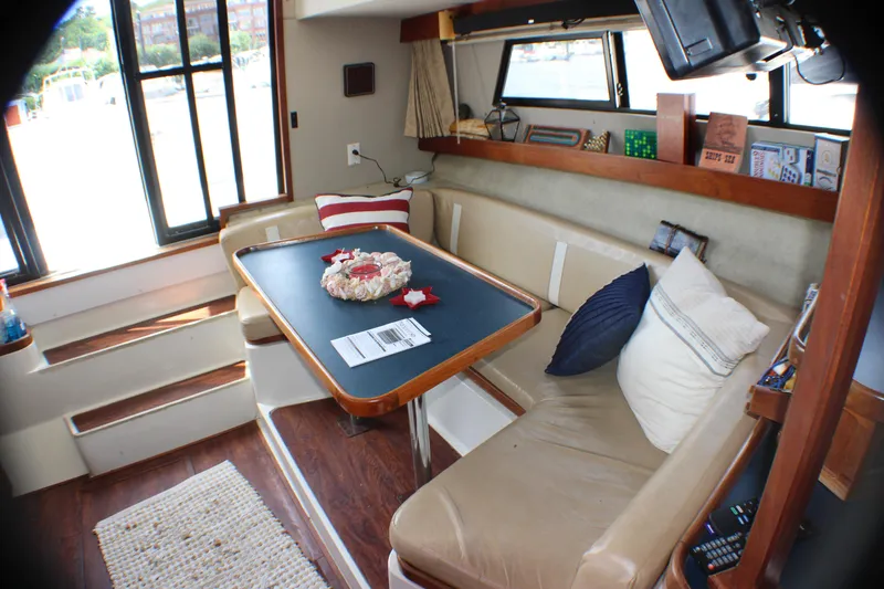 Slide: The Image of Interior of 1986 Carver 3297 Mariner yacht with dining area and seating. - 8