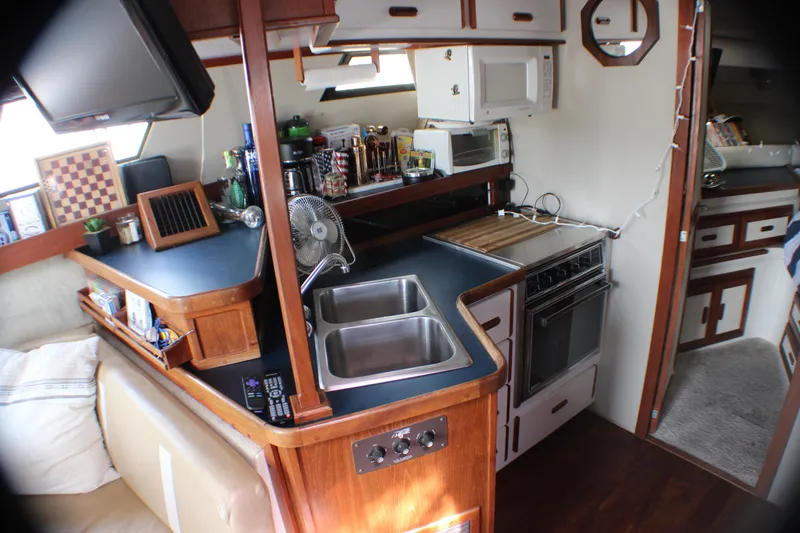 Slide: The Image of Interior of 1986 Carver 3297 Mariner yacht with kitchen and living area. - 9