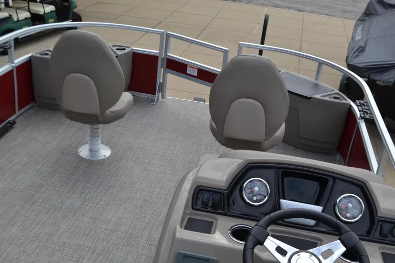 Slide: The Image of 2024 Ranger Reata 200F boat interior with steering console and seating. - 2