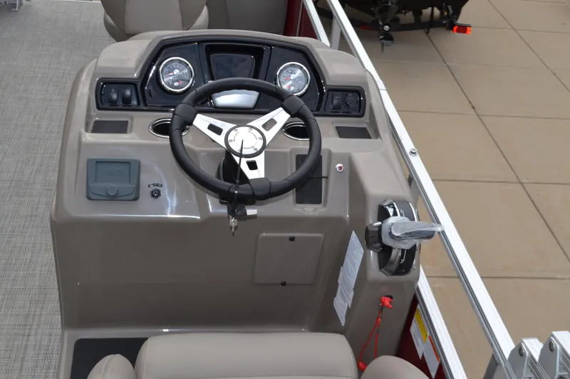 Slide: The Image of 2024 Ranger Reata 200F boat dashboard with steering wheel and control panel. - 3