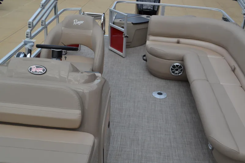 Slide: The Image of 2024 Ranger Reata 200F boat interior with beige seating and steering console. - 4