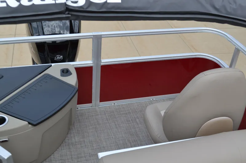 Slide: The Image of 2024 Ranger Reata 200F boat interior with beige seating and red side panel. - 5