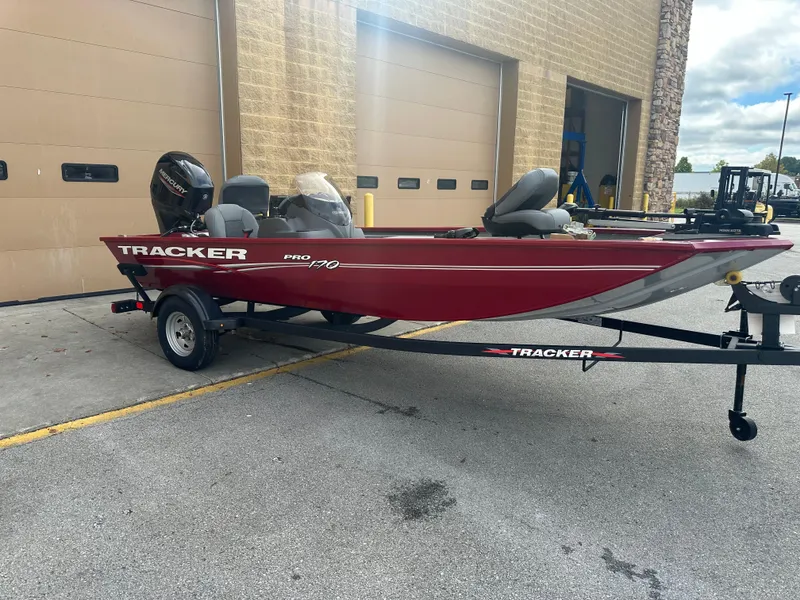 Slide: The Image of 2024 Tracker Pro 170 boat on trailer, parked outside a garage. - 3