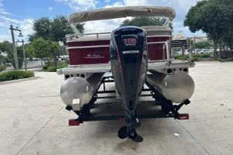 Slide: The Image of 2024 Sun Tracker Party Barge 22 RF DLX pontoon boat, rear view with motor. - 5