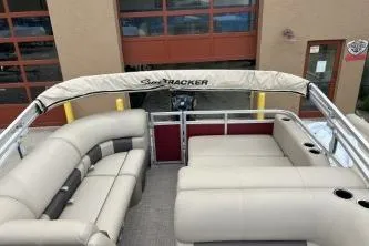 Slide: The Image of 2024 Sun Tracker Party Barge 22 RF DLX with beige seating and canopy. - 4