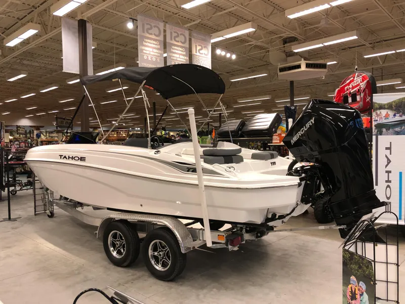 Slide: The Image of 2024 Tahoe T21 boat on display in showroom with Mercury outboard motor. - 1