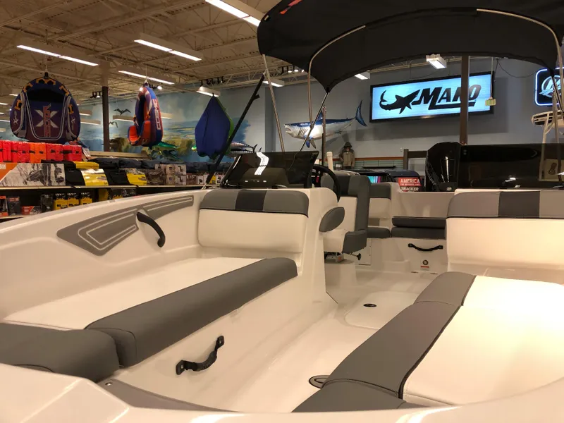 Slide: The Image of 2024 Tahoe T21 boat interior with seating and canopy in showroom. - 4