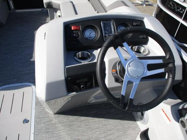 Slide: The Image of 2024 Bennington 22SXSB boat dashboard with steering wheel and gauges. - 6